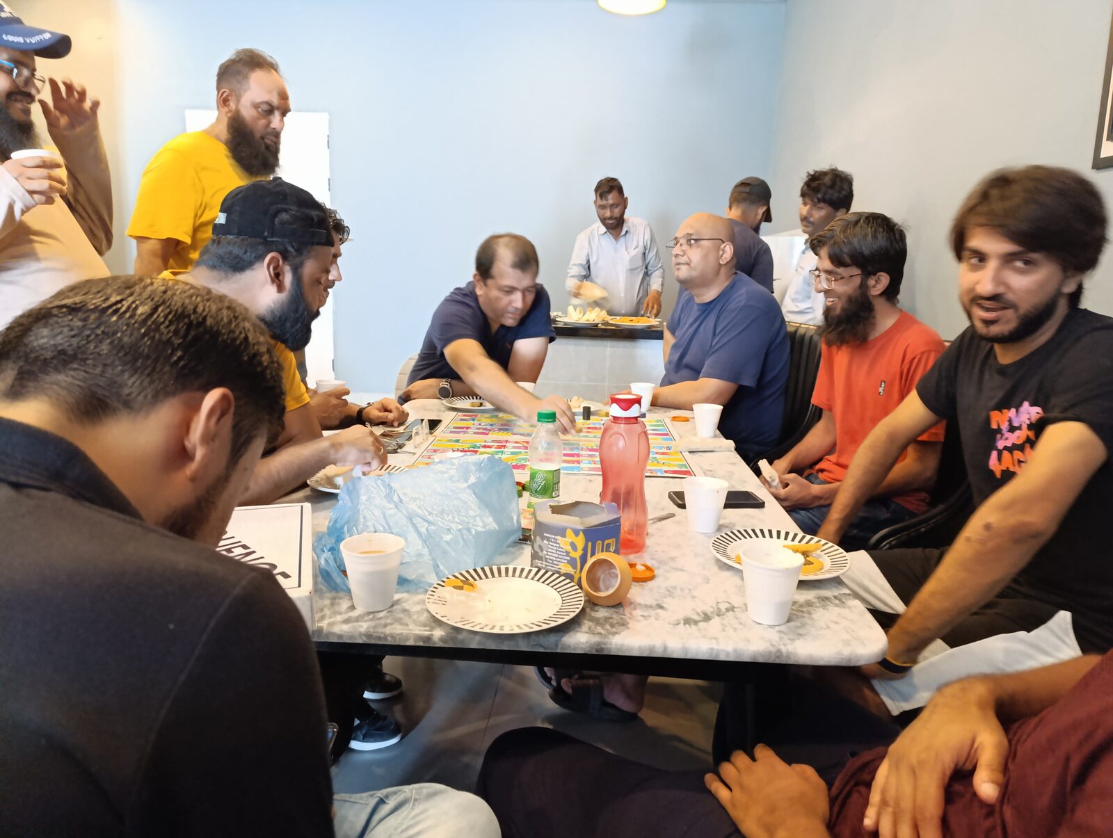 Deliverydevs picnic 2024: the team around a long dining table