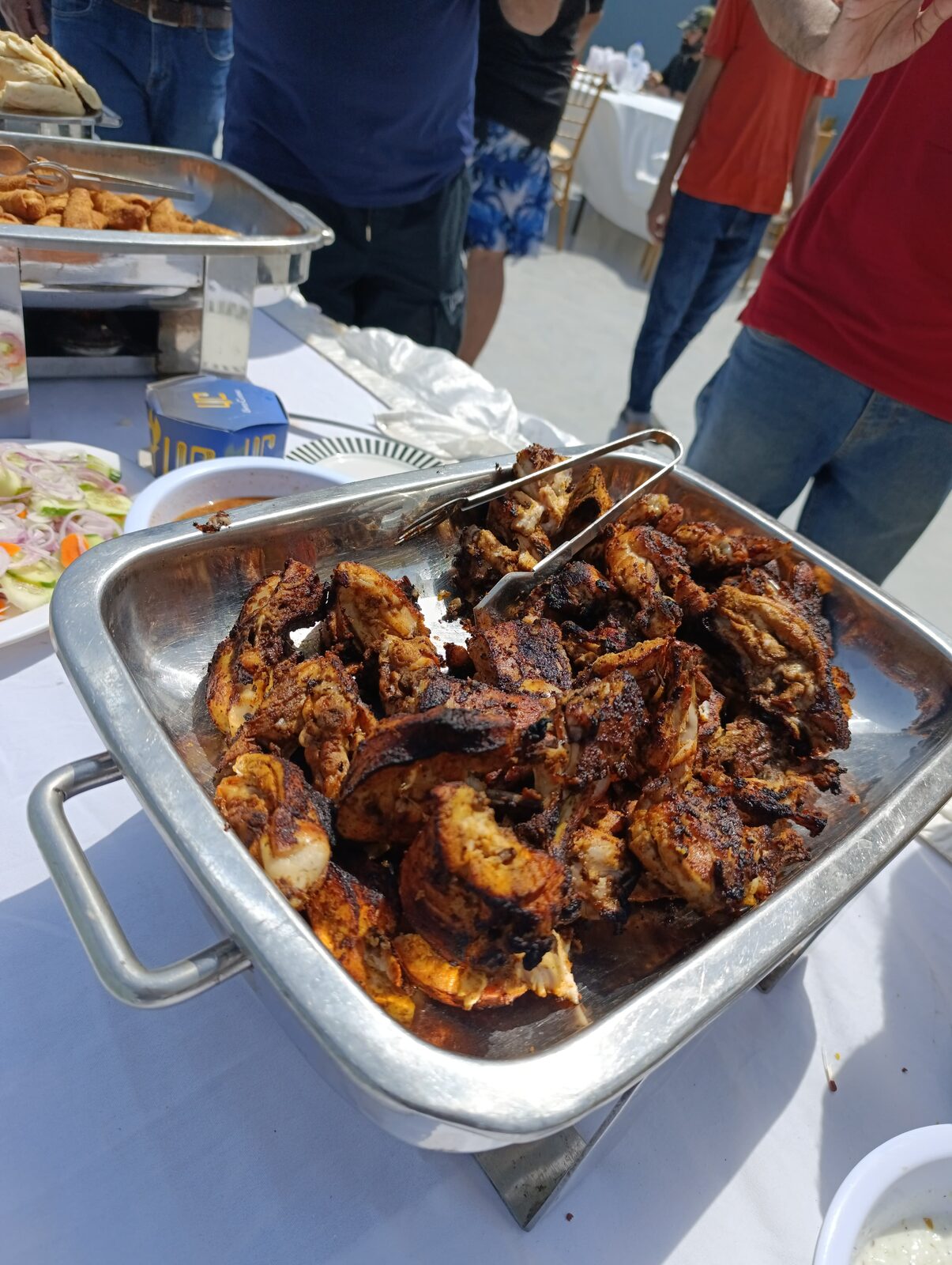 Deliverydevs picnic 2024: a tray of barbecued chicken on the buffet
