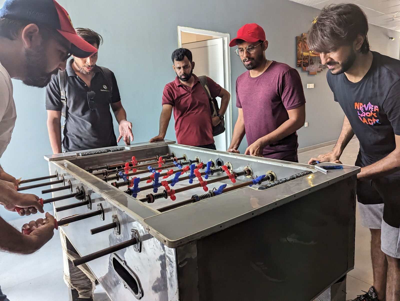 Deliverydevs picnic 2024: a foosball match in progress